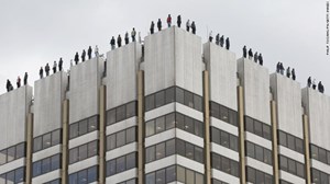 84 Male Figures, Poised to Jump from London Rooftop